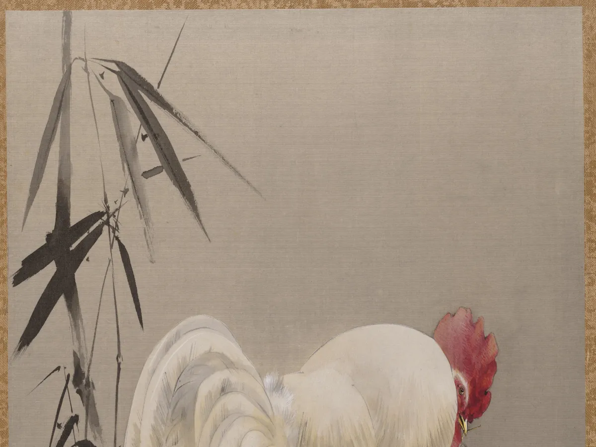 A rooster and hen under bamboo